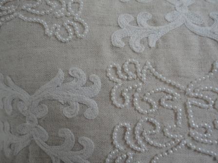 white beading and embroidery cushion