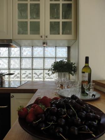 kitchen renovation after white Ikea wood benchtop glass bricks cherries